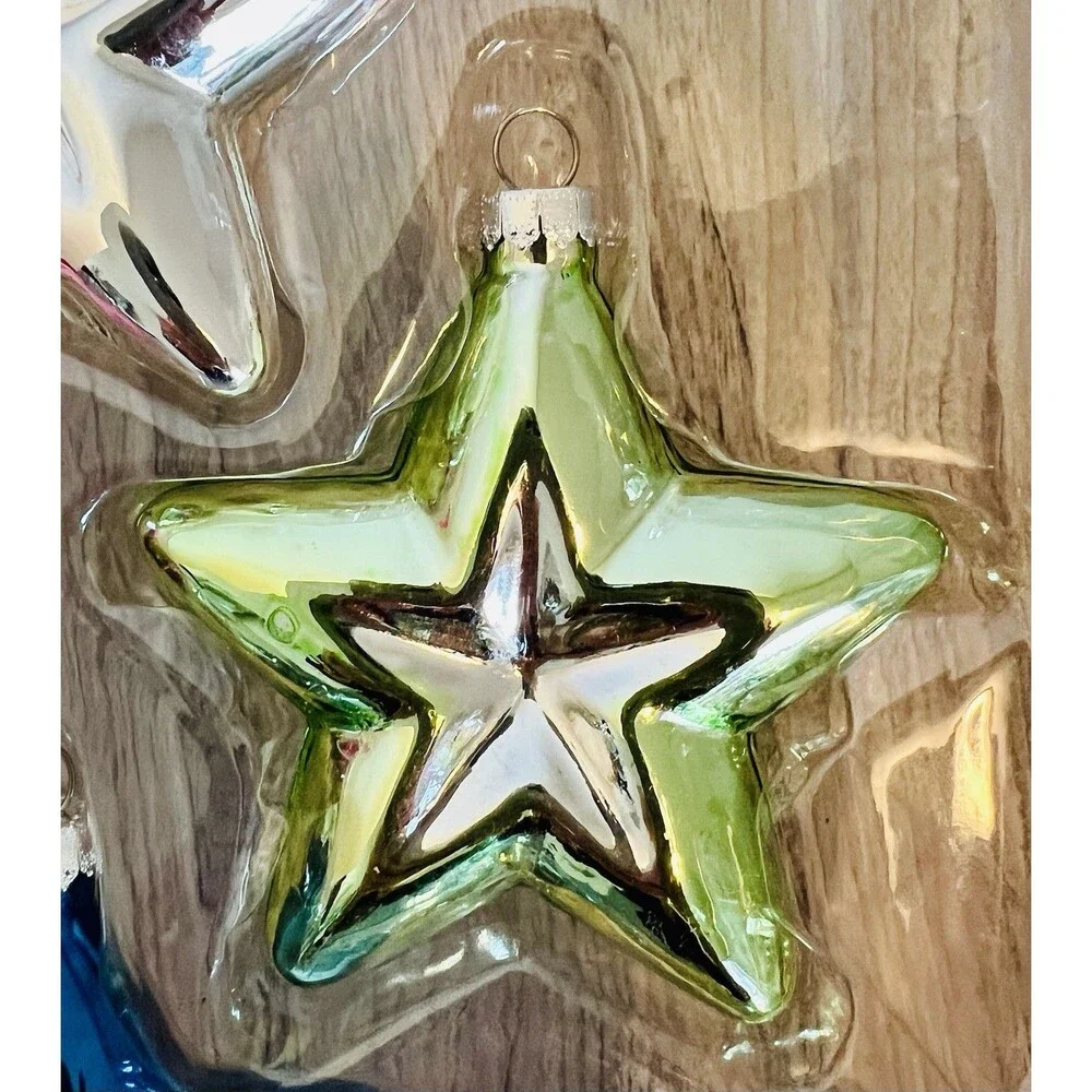 Handcrafted Glass Ornament Set features four star-shaped ornaments metallic